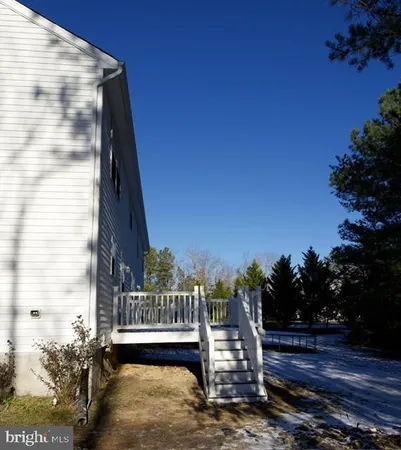 a view of balcony with wooden floor and fence
