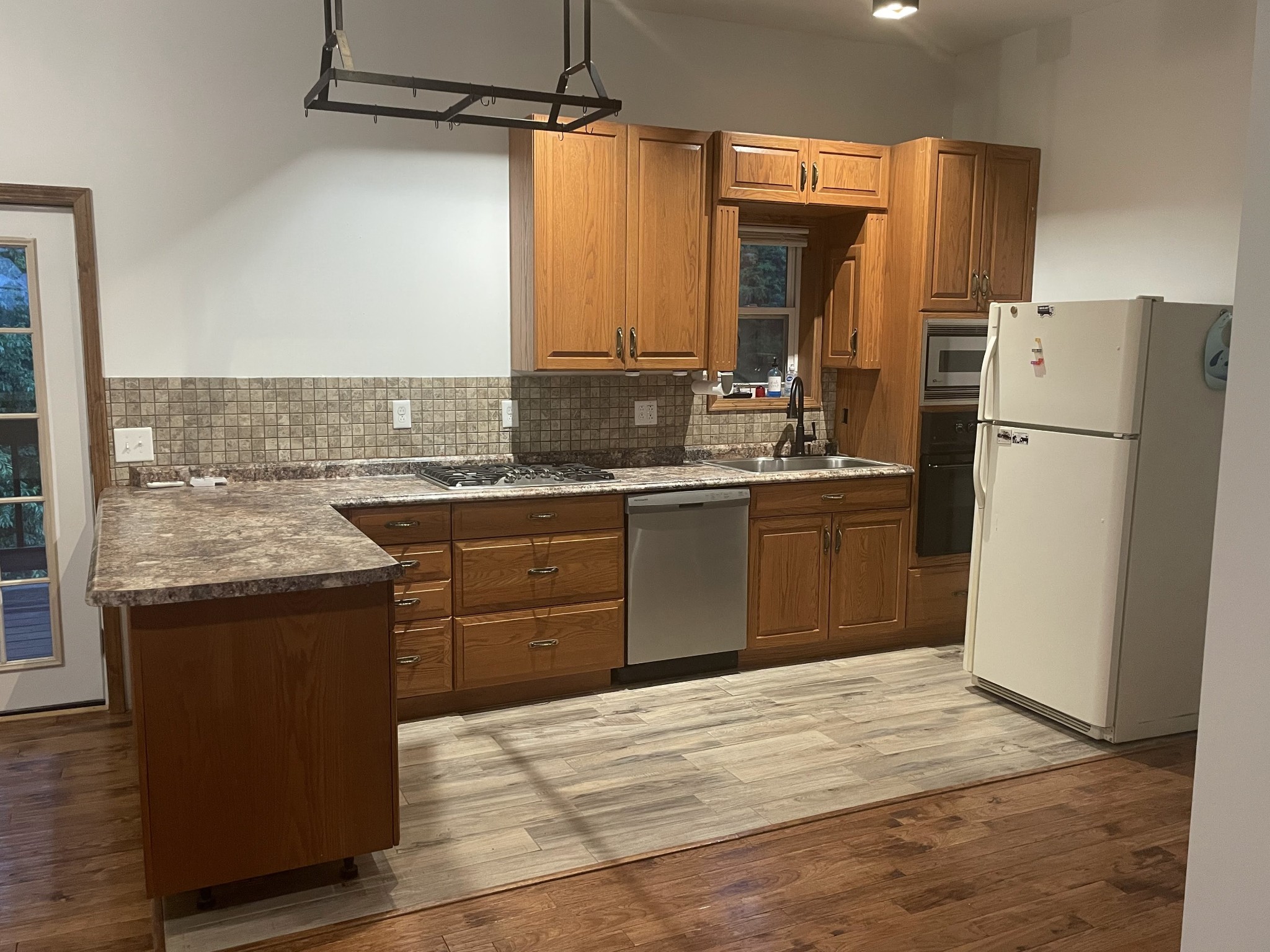 1005 Birdwell Road Red Boiling Springs, TN 37150 - Photo 17 of 59 a kitchen with a sink a refrigerator and a stove