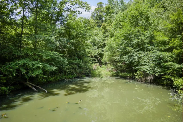 an empty room with wooden floor and cabinet