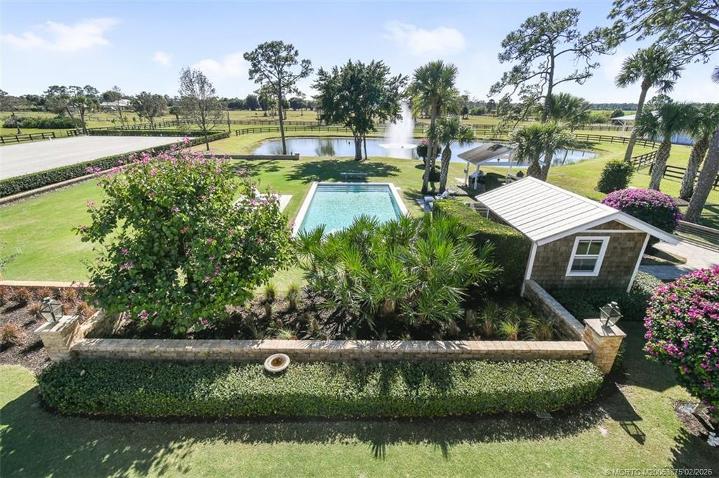 2541 Southwest Trailside Path Stuart, FL 34997 - Photo 71 of 100 a view of a lake with a house in the background