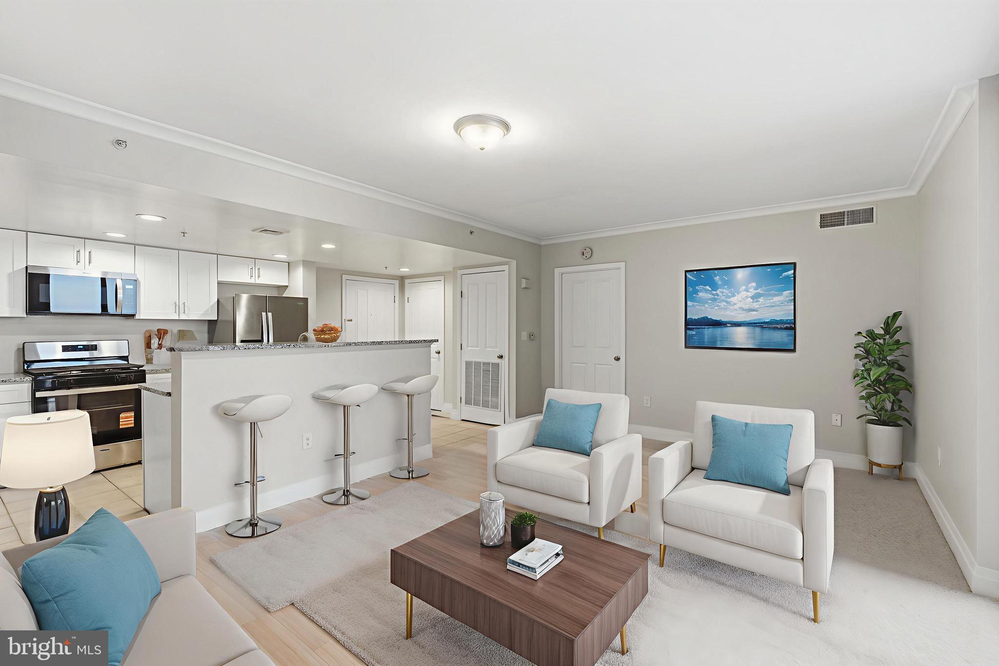 414 Water Street, Unit 1501 Baltimore, MD 21202 - Photo 11 of 21 a living room with furniture a kitchen view and a refrigerator