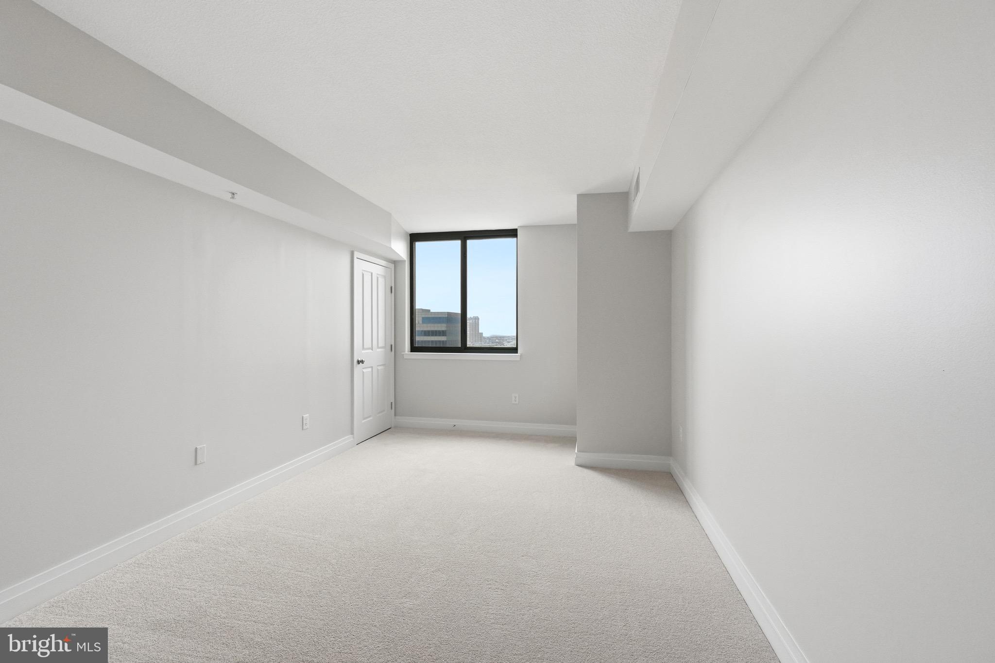 414 Water Street, Unit 1501 Baltimore, MD 21202 - Photo 14 of 21 a view of an empty room with windows