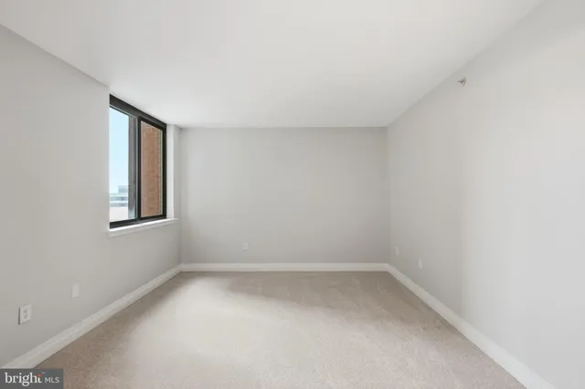 a bedroom with a bed and a lamp on table