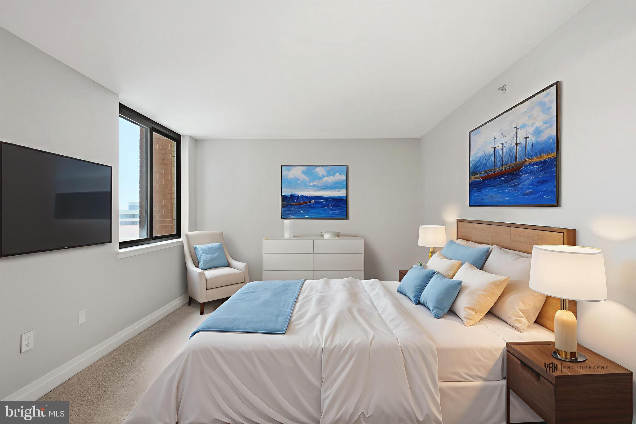 414 Water Street, Unit 1501 Baltimore, MD 21202 - Photo 17 of 21 a bedroom with a bed and a flat screen tv