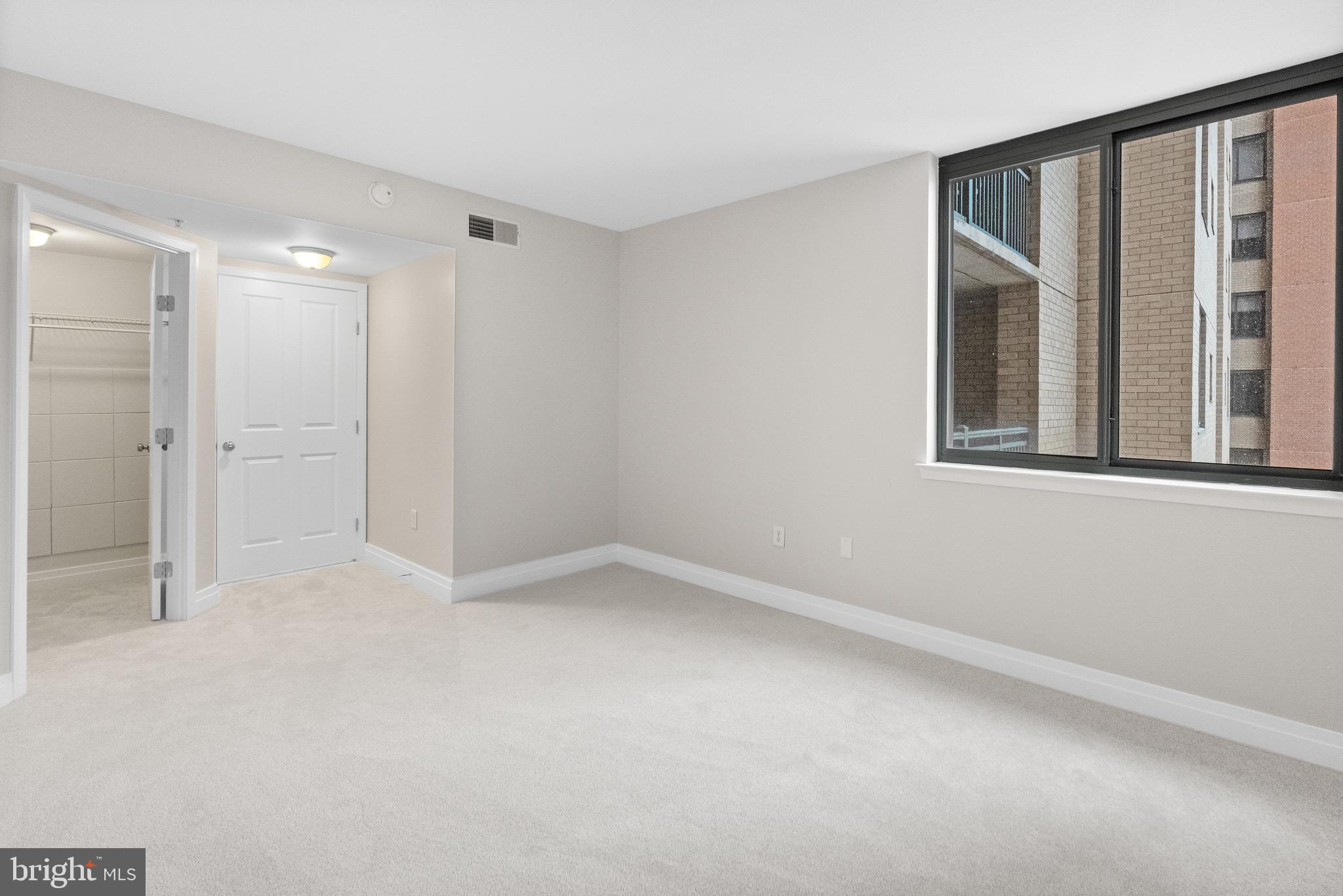 414 Water Street, Unit 1501 Baltimore, MD 21202 - Photo 18 of 21 a view of an empty room with a window