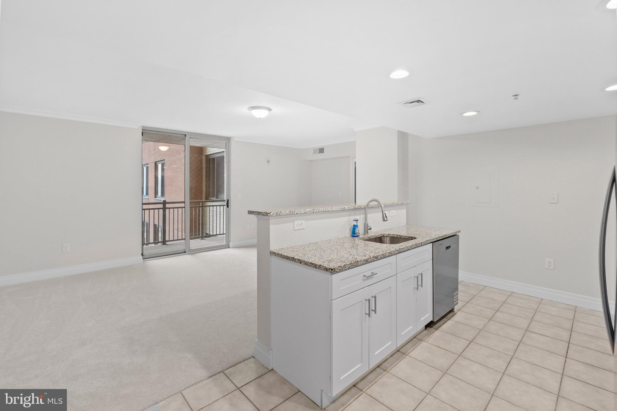 414 Water Street, Unit 1501 Baltimore, MD 21202 - Photo 7 of 21 a kitchen with a sink and cabinets