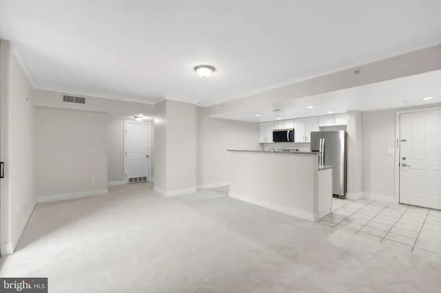 a view of a kitchen with a sink stove and a refrigerator