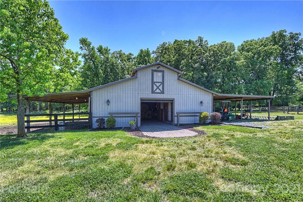 1715 Rock Rest Road, Unit PARCEL 3 Wingate, NC 28174 - Photo 5 of 48 a view of a house with a yard and sitting area