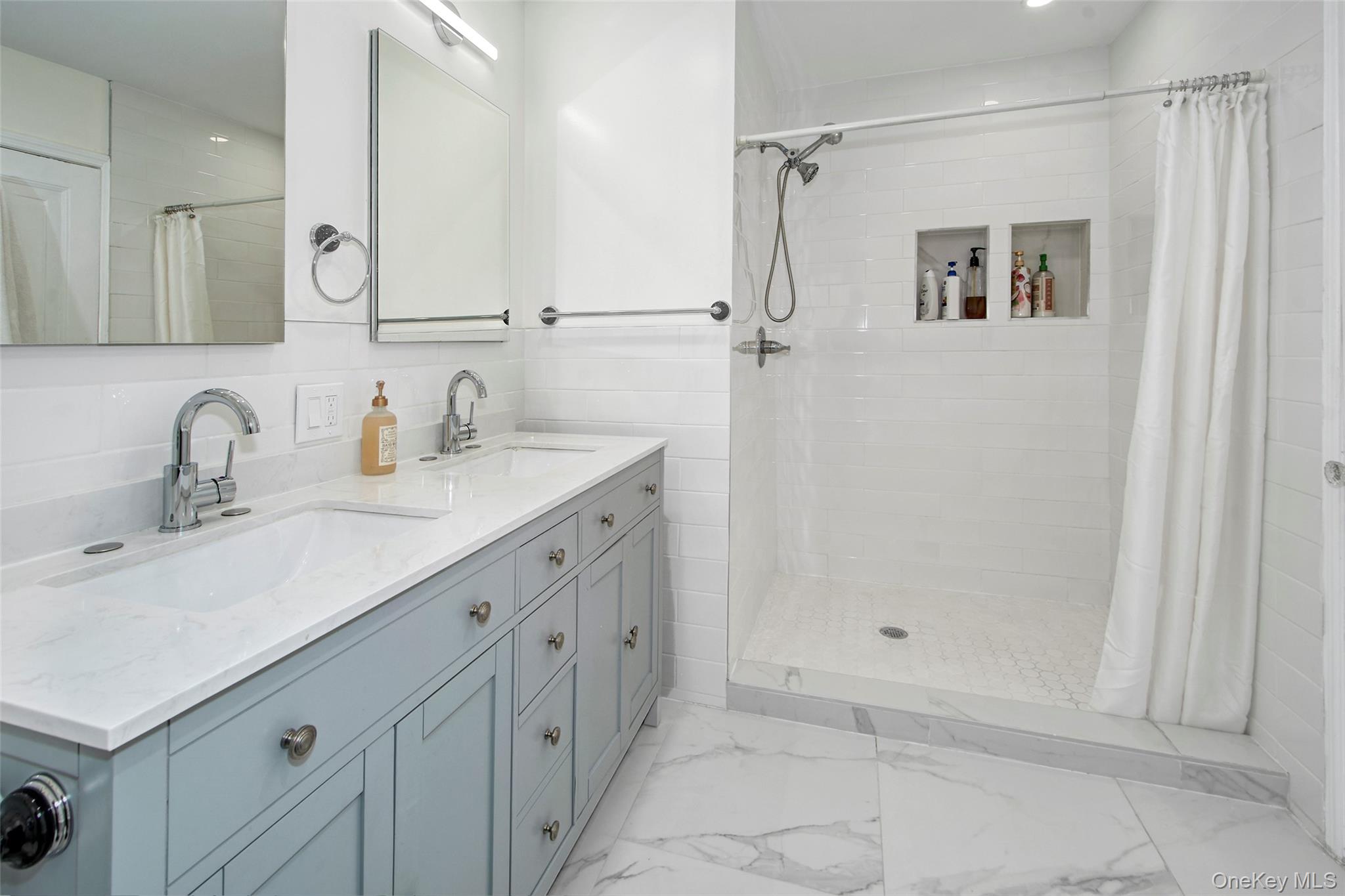 2 Byworth Road New Rochelle, NY 10804 - Photo 21 of 31 Full bathroom with marble look tile flooring, tiled shower, and double vanity