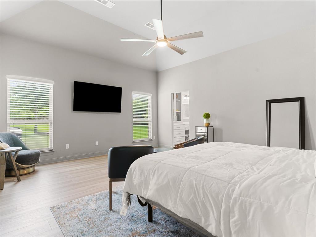 111 Old Base Road Aurora, TX 76078 - Photo 15 of 38 Private primary suite featuring generous square footage, natural light, and peaceful backyard views.
