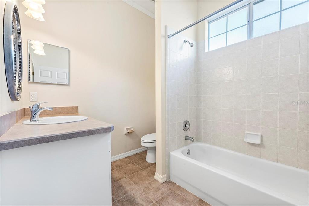 8668 Southwest 77th Avenue Gainesville, FL 32608 - Photo 17 of 29 a bathroom with a sink a toilet and shower