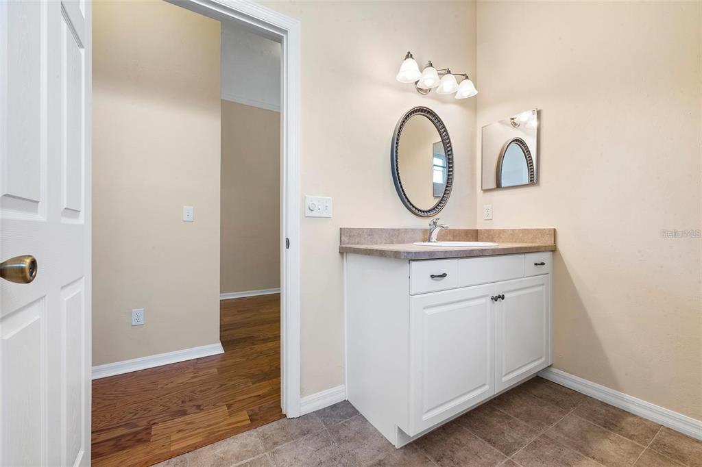 8668 Southwest 77th Avenue Gainesville, FL 32608 - Photo 18 of 29 a bathroom with a sink and a mirror