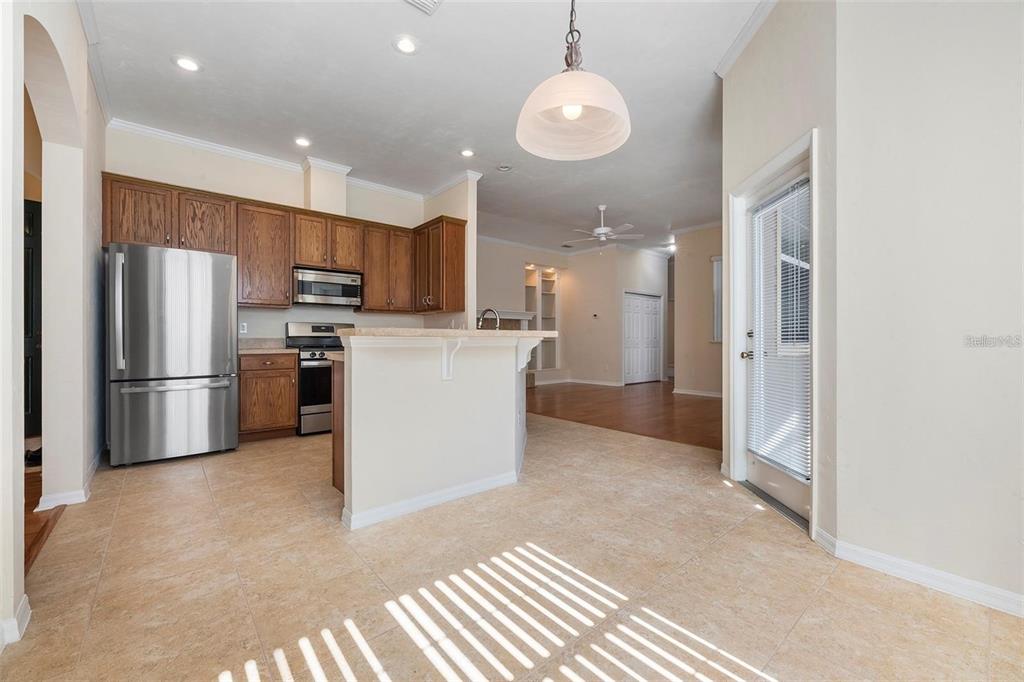 8668 Southwest 77th Avenue Gainesville, FL 32608 - Photo 10 of 29 a kitchen with refrigerator and microwave