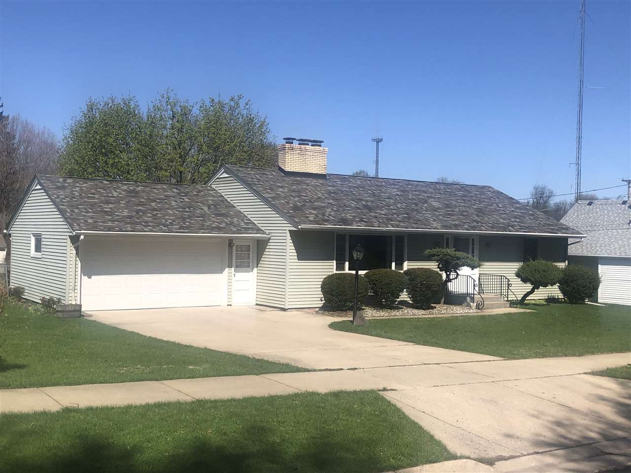 1511 Warren Road Rockford, IL 61108 - Photo 1 of 14 a front view of a house with a yard and garage