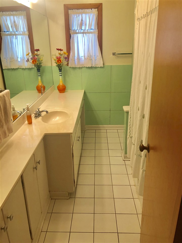 1511 Warren Road Rockford, IL 61108 - Photo 6 of 14 a bathroom with a sink toilet and shower