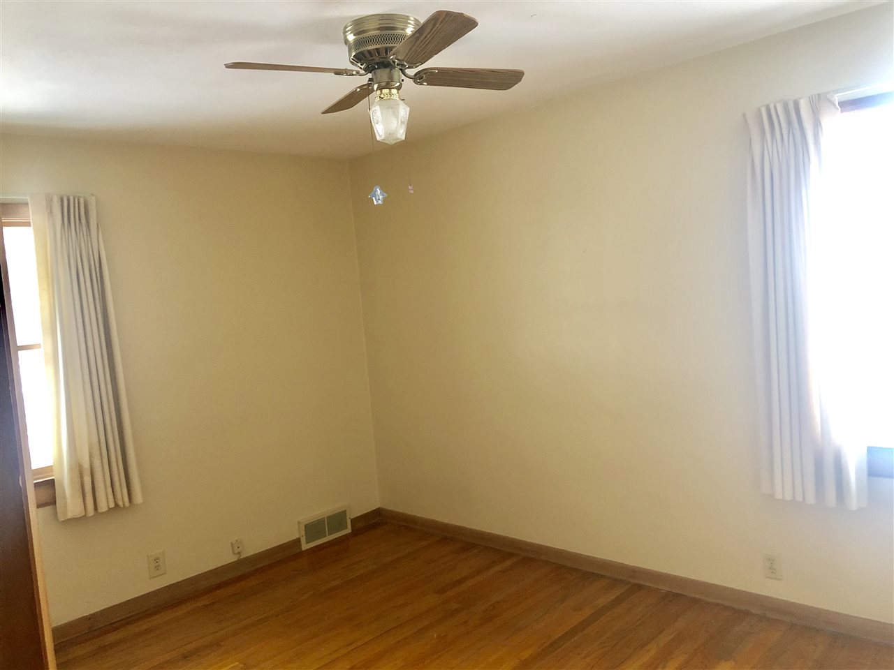 1511 Warren Road Rockford, IL 61108 - Photo 8 of 14 an empty room with a window and a ceiling fan
