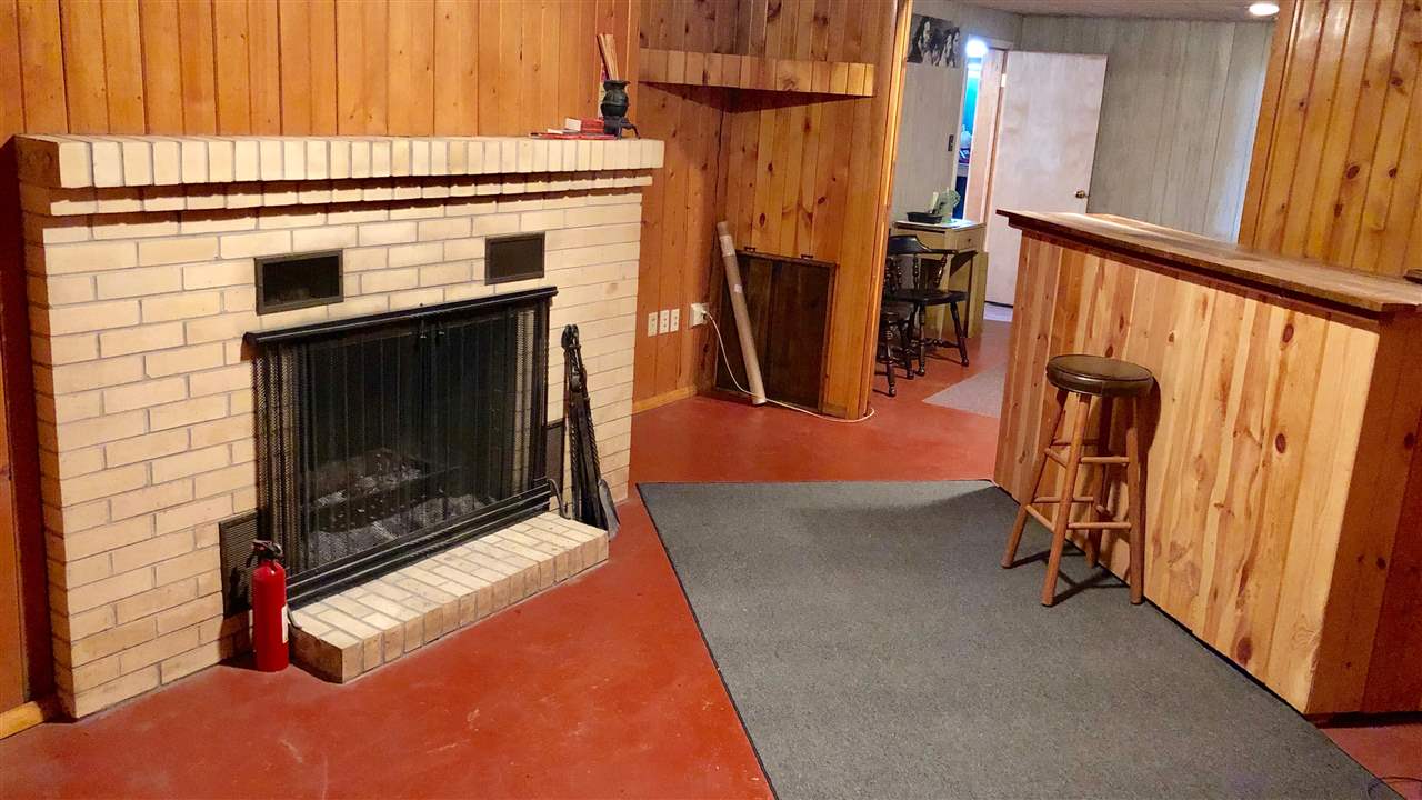 1511 Warren Road Rockford, IL 61108 - Photo 9 of 14 a view of an empty room with furniture and a fireplace