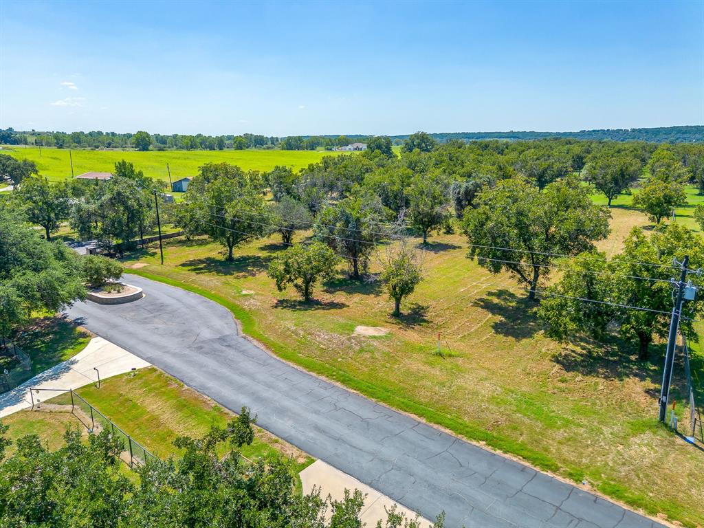 10005 Orchards Boulevard Cleburne, TX 76033 - Photo 24 of 25 a view of a swimming pool with an outdoor seating and yard
