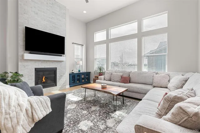 a living room with a fireplace and a flat screen tv