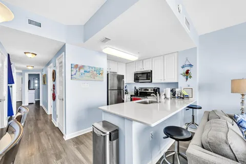 a kitchen with stainless steel appliances a refrigerator and a stove top oven