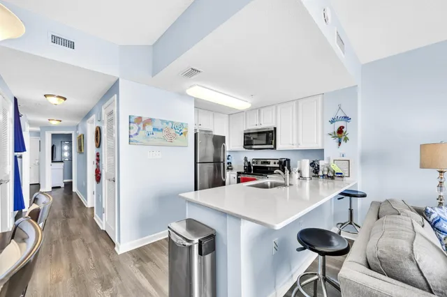 a kitchen with stainless steel appliances a refrigerator and a stove top oven