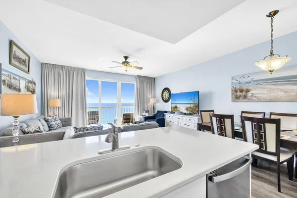 a kitchen with a stove a sink and a dining table