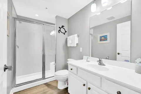 a bathroom with a sink toilet and shower