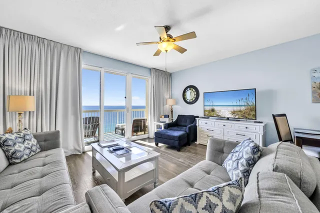 a living room with furniture a fireplace and a large window