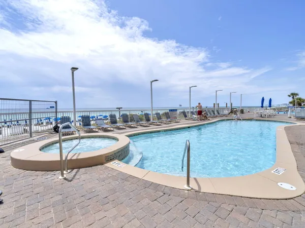 a view of a swimming pool with a lounge chair