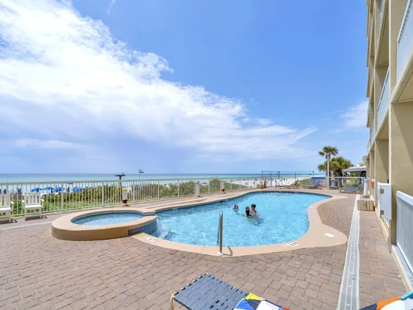a view of a house with swimming pool and sitting area