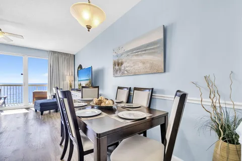 a view of a dining room with furniture and wooden floor