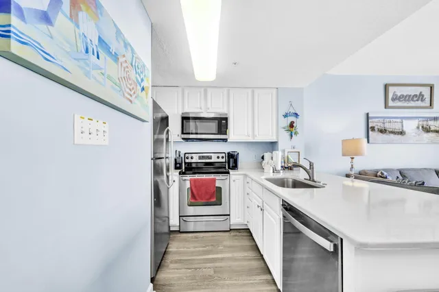 a kitchen with stainless steel appliances granite countertop a sink and a stove