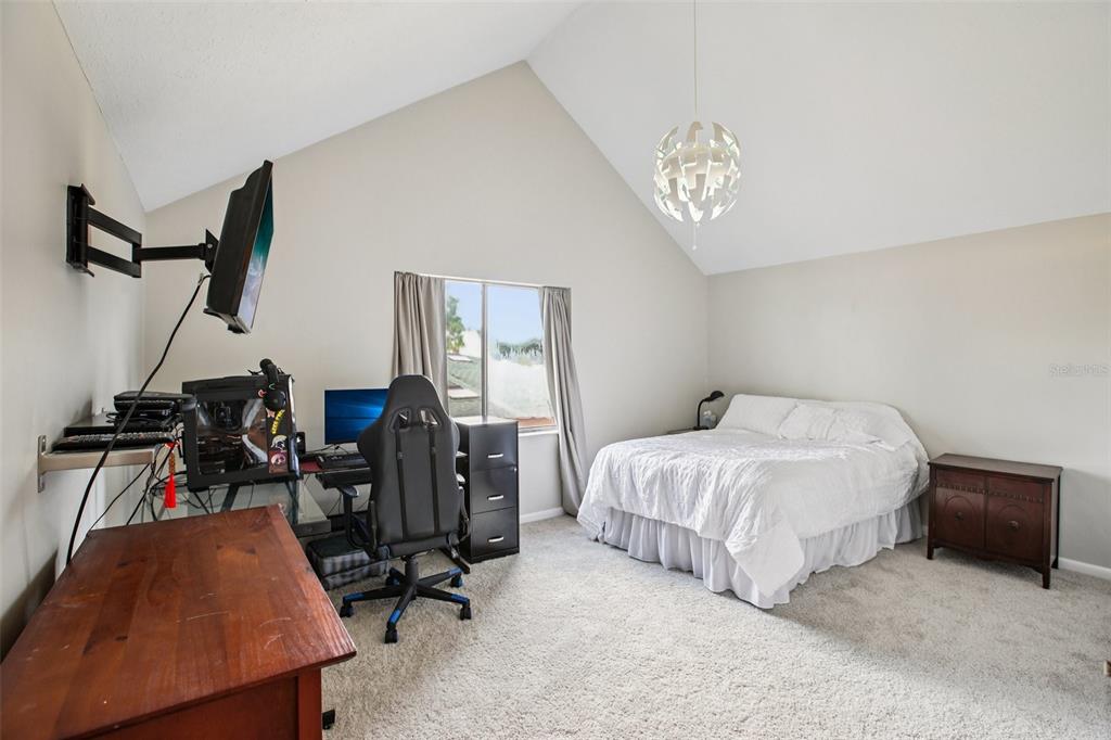 19254 Blount Road Lutz, FL 33558 - Photo 25 of 34 a bedroom with a bed gym equipment and view of living room