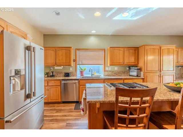 a view of kitchen island with furniture and refrigerator