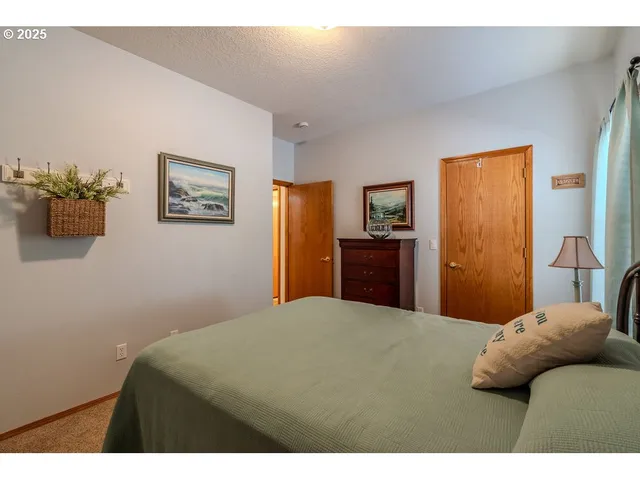 a bedroom with a bed and a dresser