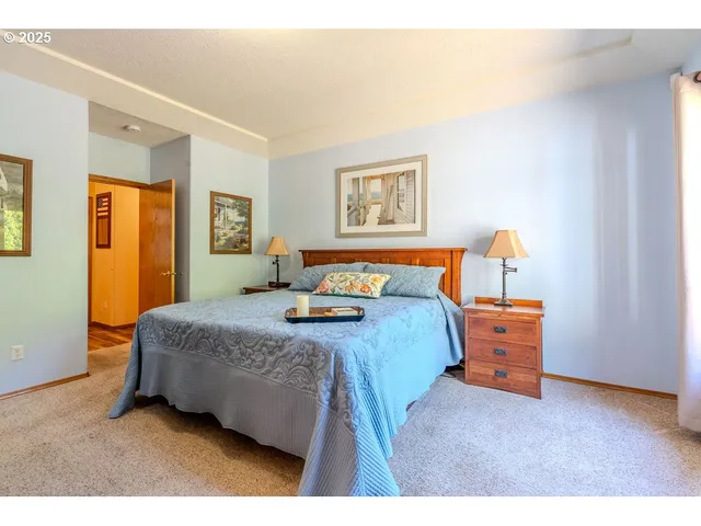 a bed sitting in a bedroom next to a window