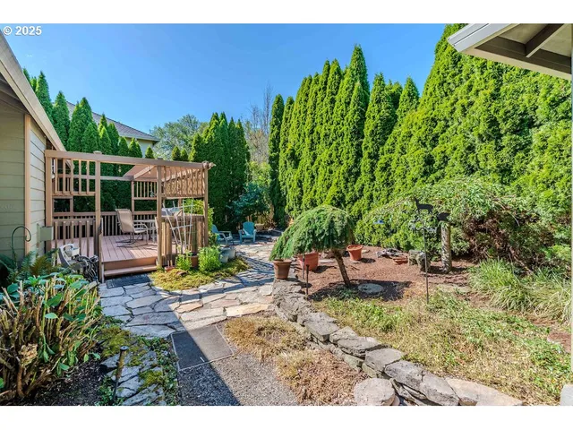 a view of backyard with outdoor seating and green space