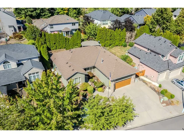 an aerial view of a house with a yard and outdoor seating