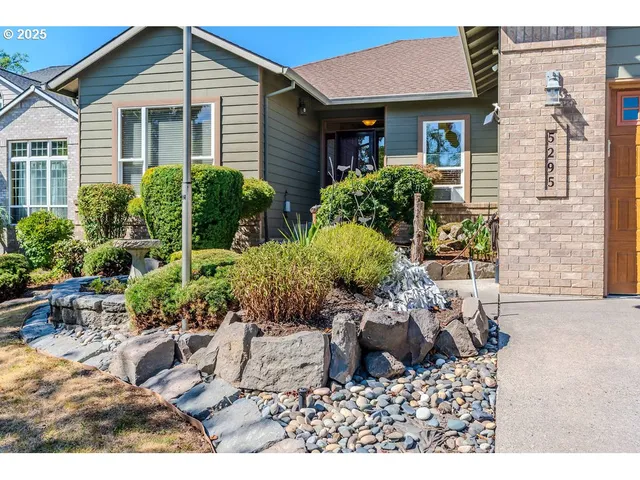 a view of a house with a yard and sitting area