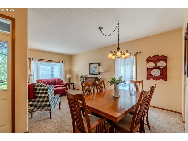 a dining room with furniture and chandelier