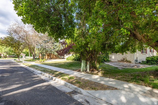 1365 Sumac Drive Logan, UT 84321 - Photo 6 of 66 Mature trees frame the front yard and a portion of the white brick exterior