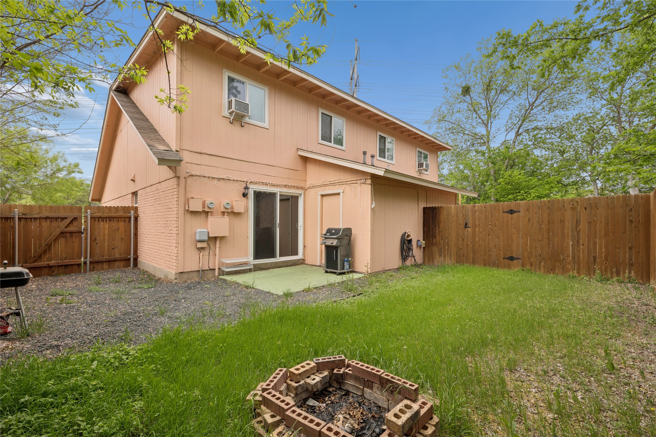 820 Sahara Avenue, Unit B Austin, TX 78745 - Photo 14 of 29 Rear view of house featuring a gate, a patio, a fenced backyard, and an outdoor fire pit