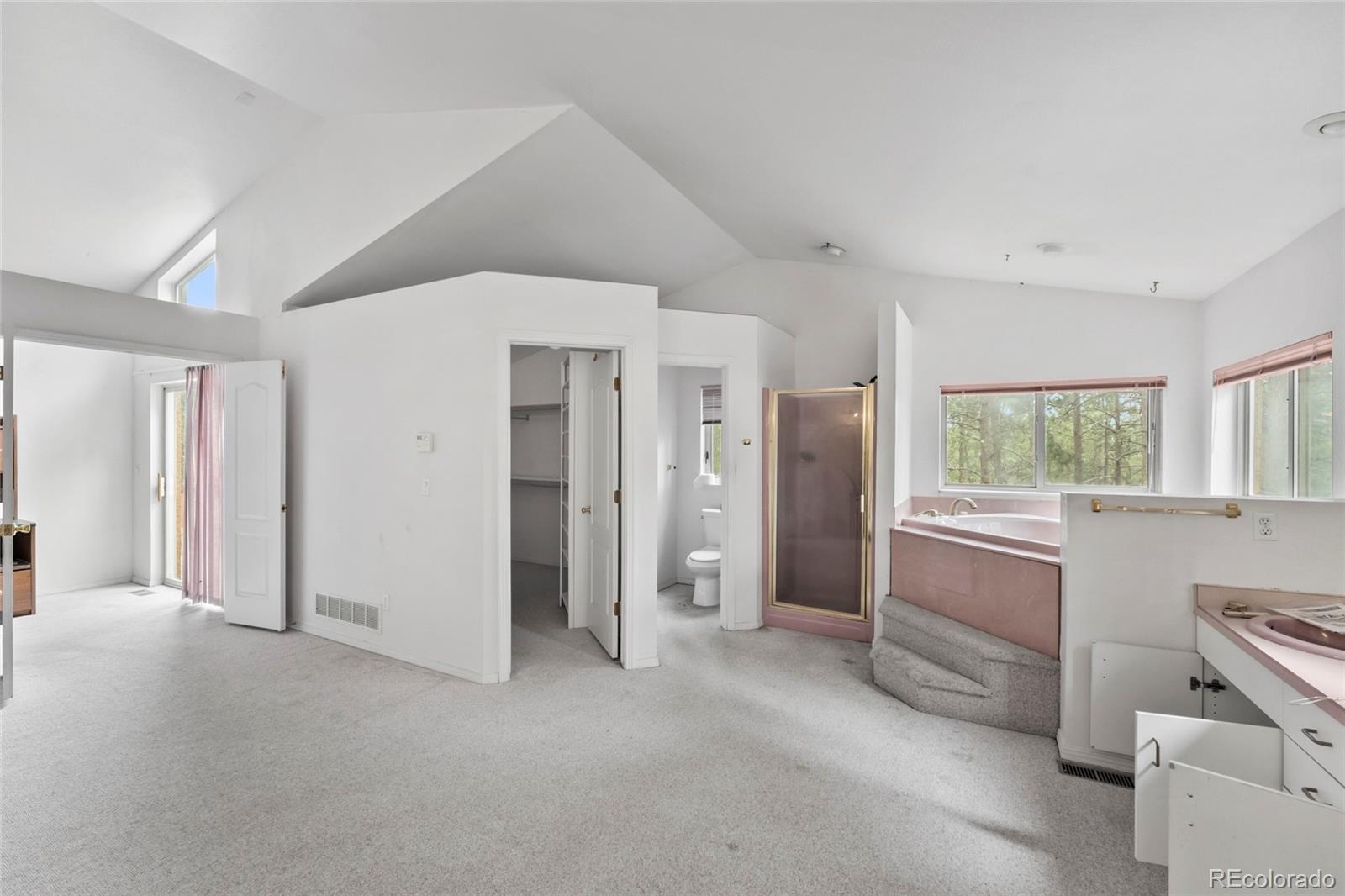 16575 Roller Coaster Road Colorado Springs, CO 80921 - Photo 13 of 26 a large white room with closet and large window