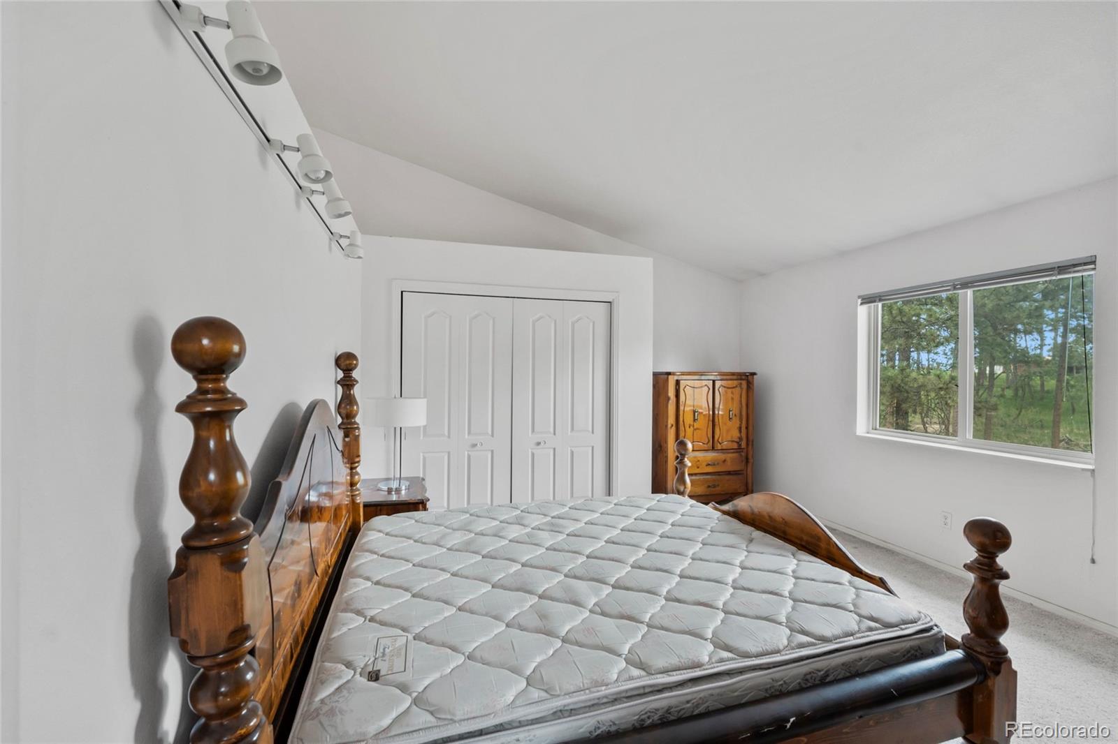 16575 Roller Coaster Road Colorado Springs, CO 80921 - Photo 14 of 26 a bedroom with furniture and a window