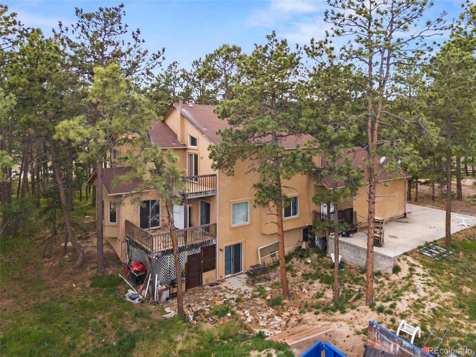 16575 Roller Coaster Road Colorado Springs, CO 80921 - Photo 25 of 26 an aerial view of residential house with outdoor space and trees all around