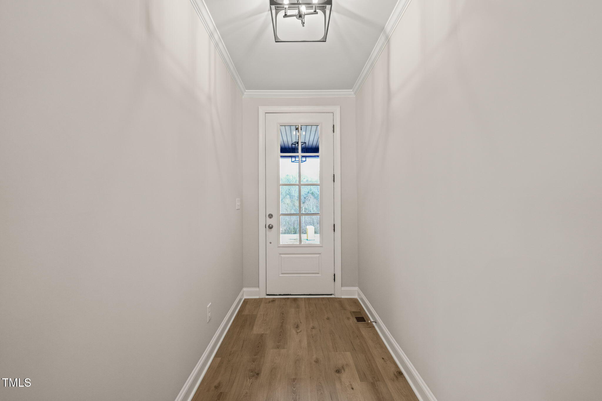 140 Pilot Ridge Road Zebulon, NC 27597 - Photo 3 of 29 a view of an empty room with wooden floor and a window