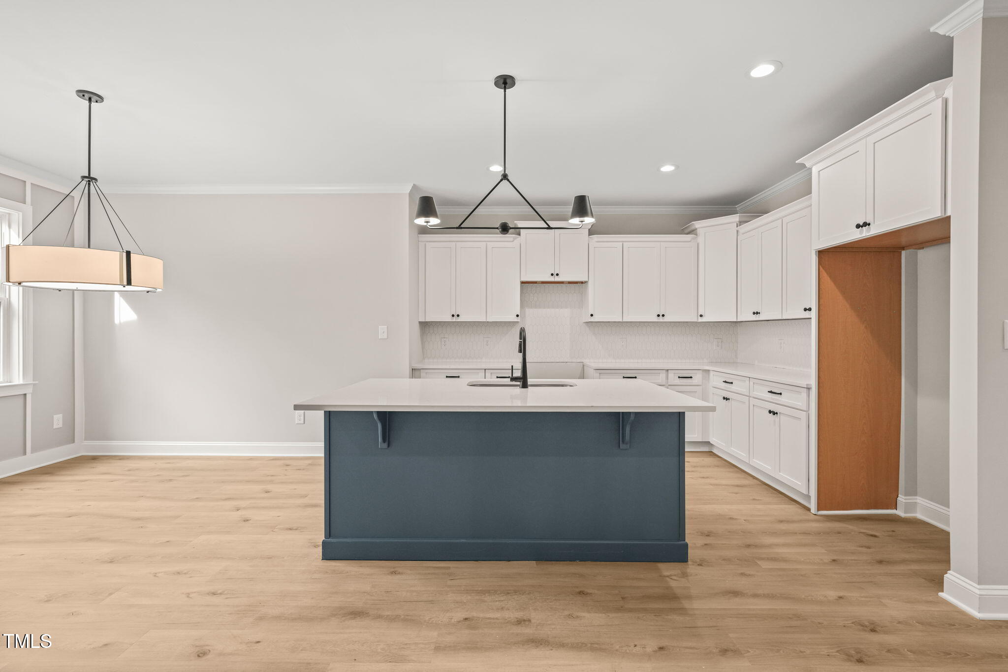140 Pilot Ridge Road Zebulon, NC 27597 - Photo 7 of 29 a kitchen with kitchen island a sink stainless steel appliances and cabinets