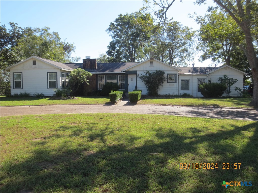a view of a house with a yard and tree s
