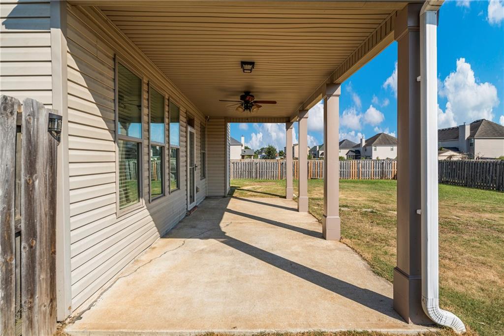 12 Juno Street Fort Mitchell, AL 36856 - Photo 39 of 43 Fenced backyard featuring a ceiling fan, a patio area, and a residential view