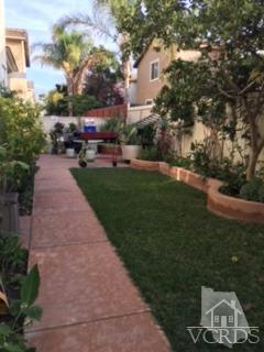 832 Pontoon Way Oxnard, CA 93035 - Photo 22 of 24 a front view of a house with a garden and car parked
